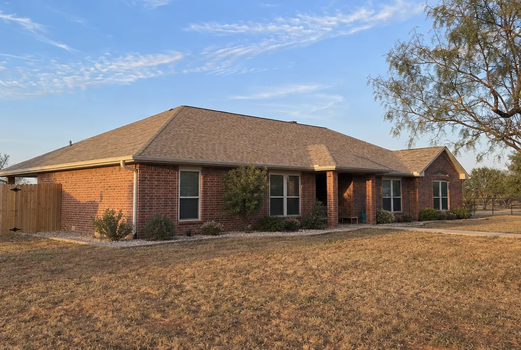 After: the same ranch house with a finished new roof.